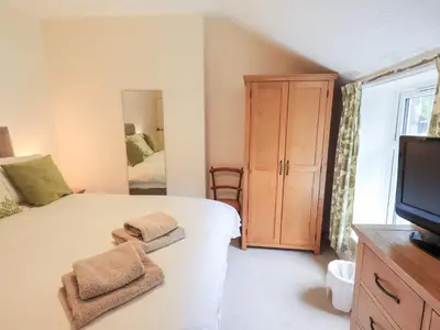 a bedroom with a bed with towels on it at Millcroft in Penrith