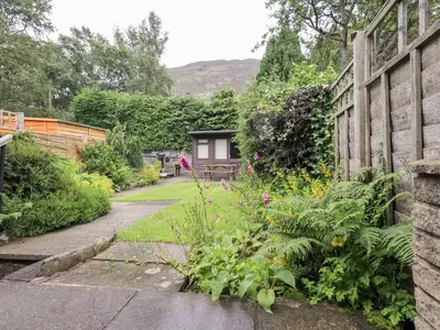 a garden with some plants and a building at Millcroft in Penrith