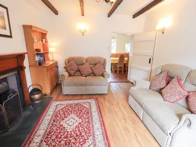 a living room with two couches and a fireplace at Millcroft in Penrith