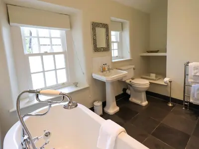a bathroom with a tub and a toilet and a sink at Beck Steps 1 in Grasmere