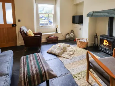 a living room with a couch and a fire place at Beck Steps 1 in Grasmere