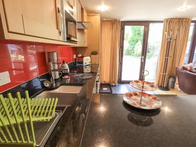 a kitchen with a counter top with a sink and a counter sidx sidx at Stonegarth Mews in Ambleside