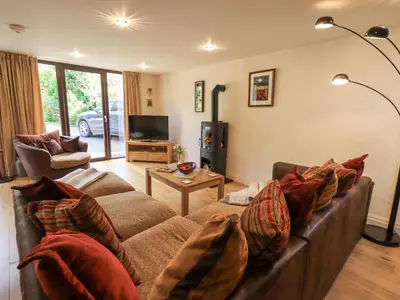 a living room with a couch and a tv at Stonegarth Mews in Ambleside