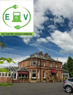 a picture of a large brick building with a car parked in front at Somerton House Hotel in Lockerbie