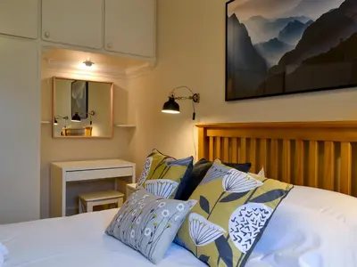 a bed with blue and white pillows in a bedroom at Linton in Keswick