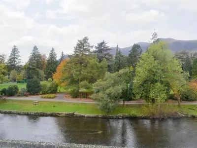 a view of a park with trees and a river at Linton in Keswick