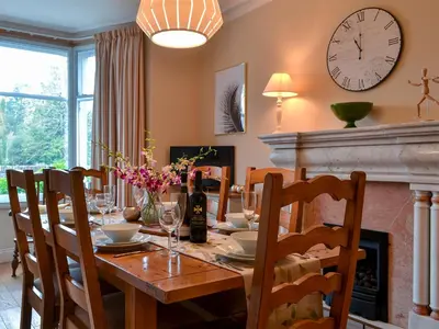 a dining room with a table and a fireplace at Linton in Keswick