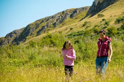 two girls walking in a field of tall grass at Woodland Bay Hotel in Girvan