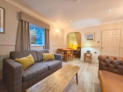 a living room with a couch and a table at Derwent Manor Apartments in Keswick