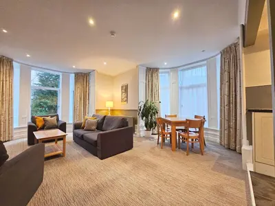 a living room with a couch and a table at Derwent Manor Apartments in Keswick