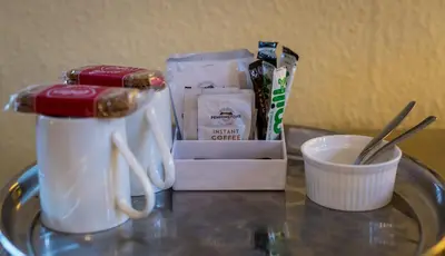 a table with a blender and a cup of coffee at Portland House in Keswick