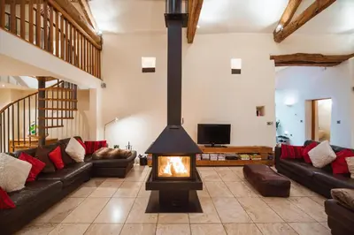 a living room with a fireplace and couches at The Lazy Fish in Cockermouth