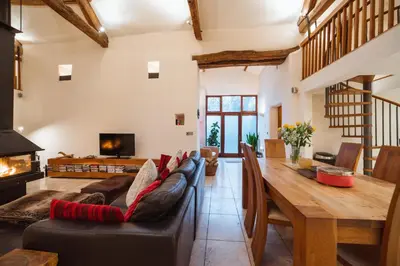 a living room with a couch and a wooden table at The Lazy Fish in Cockermouth