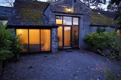 a house with a hose attached to the side of it at The Lazy Fish in Cockermouth