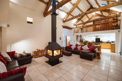a living room with a fireplace in the middle at The Lazy Fish in Cockermouth