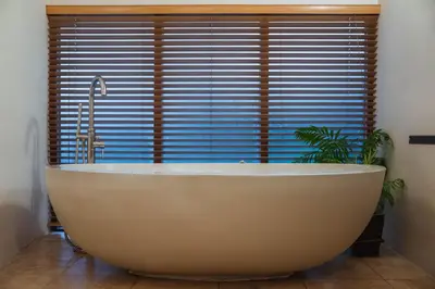 a bath tub in a bathroom with a large window at The Lazy Fish in Cockermouth