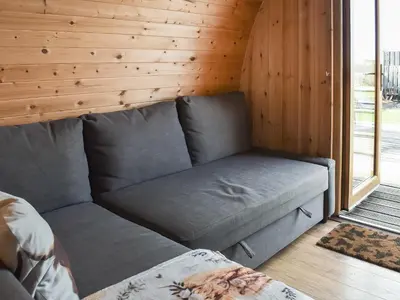 a couch in a room with a wooden wall at Black Coombe-Uk1392 in Corney