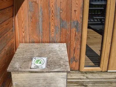 a sign sitting on a bench in front of a door at Stainton-Uk1395 in Corney