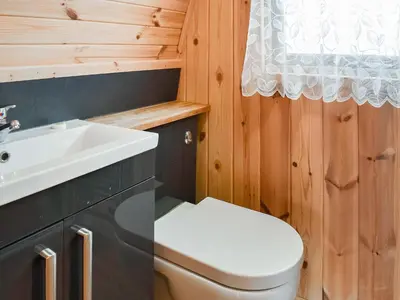 a bathroom with a toilet and a sink at Barn Scar-Uk1394 in Corney
