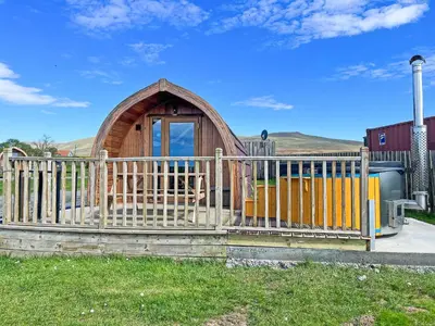 a small wooden cabin behind a wooden fence at Selker View-Uk1397 in Corney