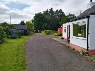 an empty road next to a small house at Bonshawbrae in Kirtlebridge