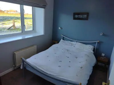a bed in a bedroom with a window at Bonshawbrae in Kirtlebridge