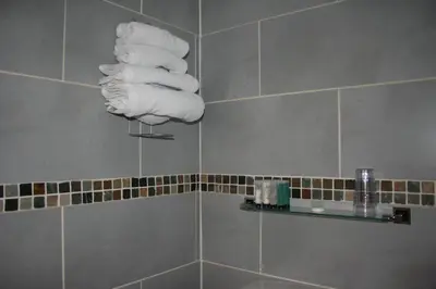 a bathroom with a bunch of towels hanging on a wall at Royal Hotel in Girvan