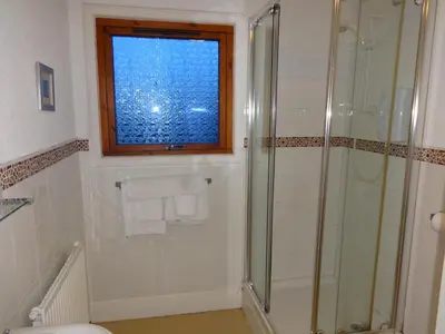 a bathroom with a shower and a window at Aberdour Guest House in Dumfries