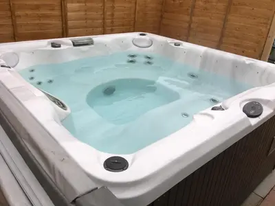 a jacuzzi tub in a bathroom with at Sunset Retreat Lodge with Hot Tub in Carsethorn
