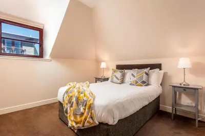 a bedroom with a bed and a window at Elliot Suite No9 - Donnini Apartments in Ayr