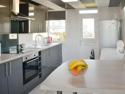 a kitchen with a bowl of fruit on a table at Wavecrest in Mainsriddle