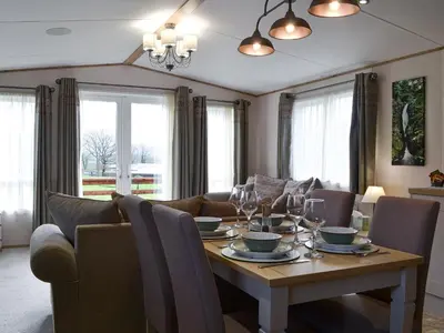 a dining room with a table and a couch at Watches - Uk13544 in Bassenthwaite