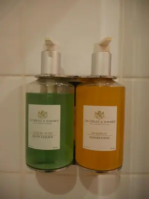 two bottles of soap sitting on a shelf at The Sleepwell Inn in Workington