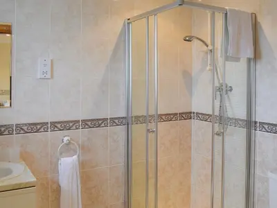 a shower with a glass door in a bathroom at West Tannacrieff in Stewarton
