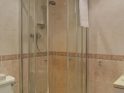 a shower with a glass door in a bathroom at West Tannacrieff in Stewarton