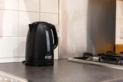 a coffee pot sitting on a counter next to a stove at Elliot Suite No 1 - Donnini Apartments in Ayr
