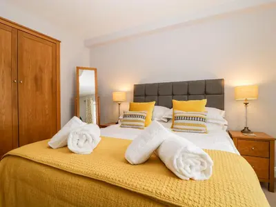 a bedroom with a large bed with towels on it at High Spy in Keswick