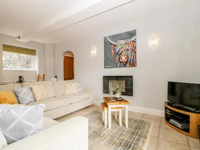 a living room with a couch and a tv at High Spy in Keswick