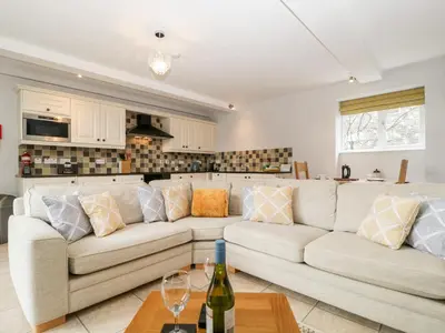 a living room with a couch and a kitchen at High Spy in Keswick