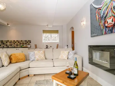 a living room with a white couch and a table at High Spy in Keswick