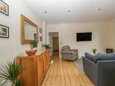 a living room with a couch and a mirror at Hillcrest in Newton Stewart