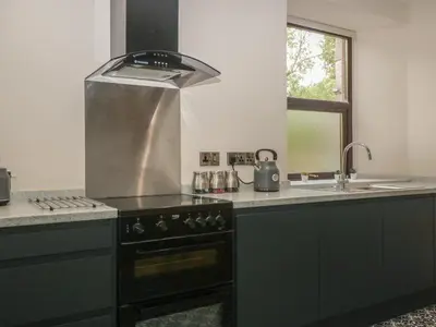 a kitchen with a stove and a sink at Hillcrest in Newton Stewart