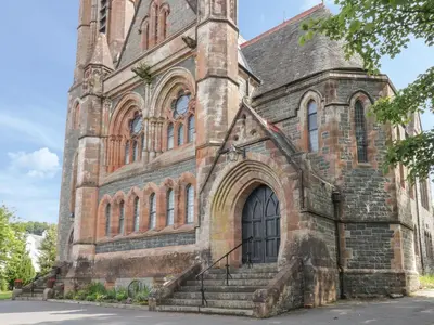 an old brick church with stairs in front of it at Duplex in Moffat