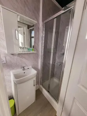 a bathroom with a shower and a sink at At Caledonia in Douglas
