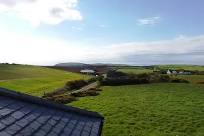a roof of a house in a green field at Castlemoor Holiday Cottage, Mull of Galloway in Drummore