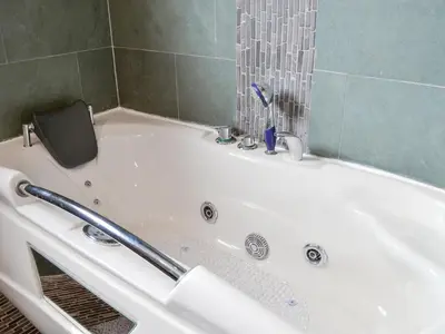a white bath tub with a toothbrush in it at West Fells Cottage in Arlecdon