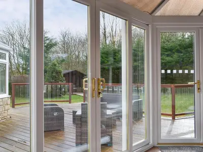a screened in porch with sliding glass doors at West Fells Cottage in Arlecdon