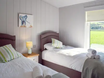 a bedroom with two beds and a window at Willow Lodge - Uk13637 in Creetown