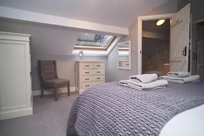 a bedroom with two beds and a dresser and a window at Bakers Rest ideal for 2 families centrally located in Grasmere with walks from the door in Grasmere