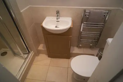 a small bathroom with a toilet and a sink at Bakers Rest ideal for 2 families centrally located in Grasmere with walks from the door in Grasmere
